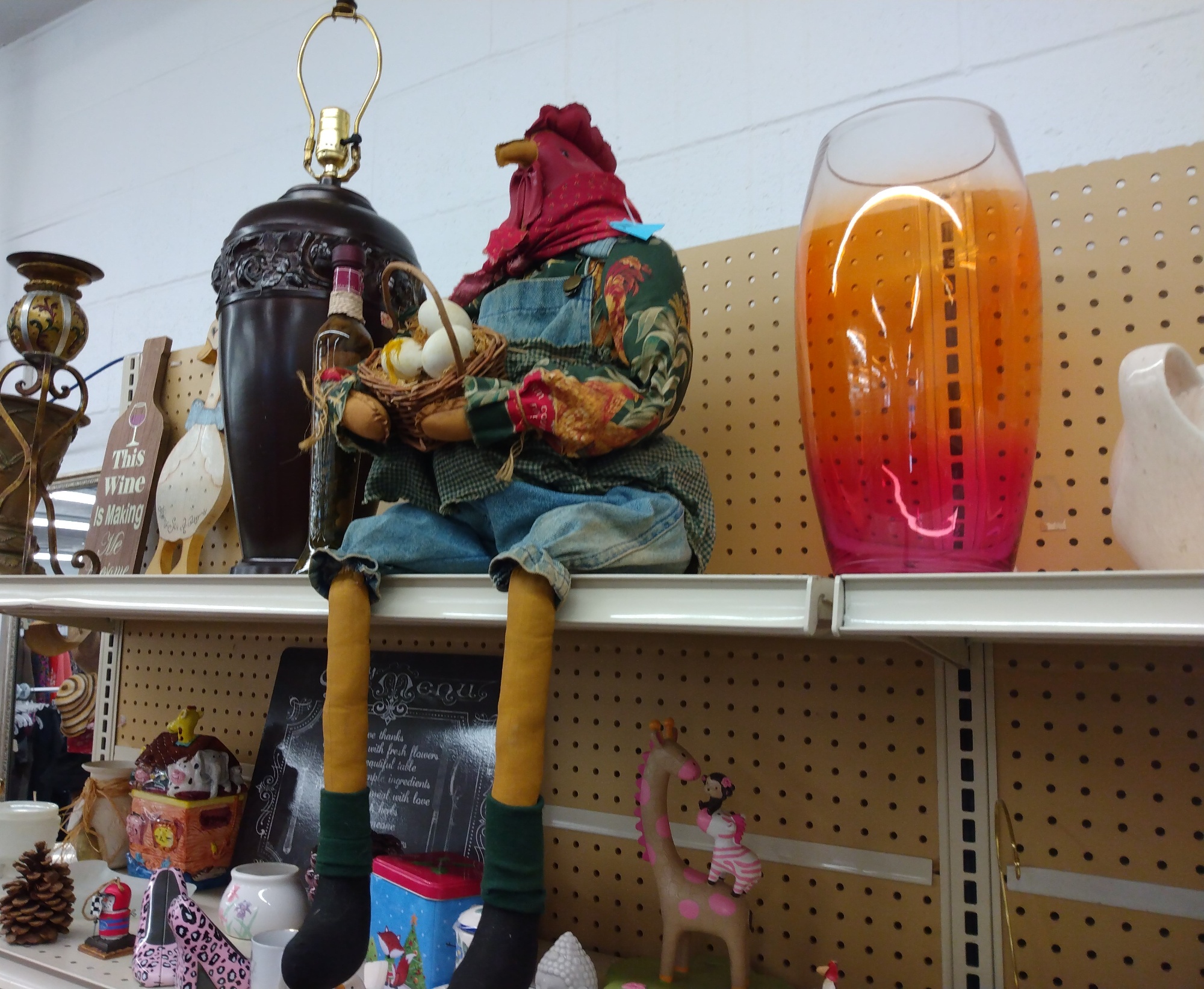 An image of unique lamps sitting on a shelf at a thrift store
